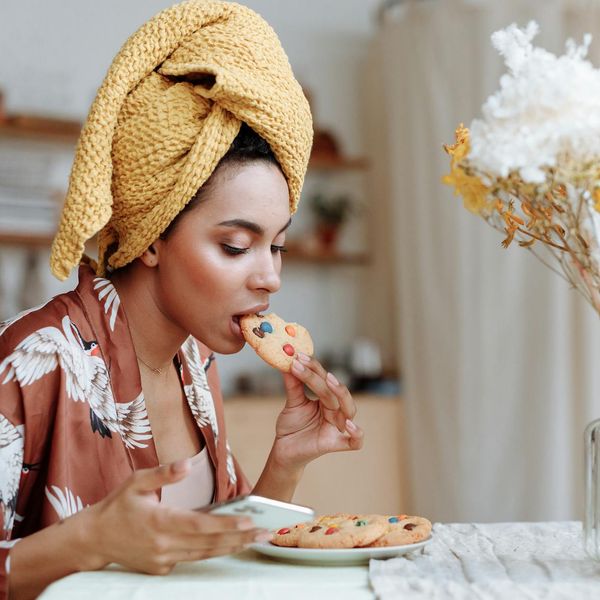 Comfortable home corner with a yoga mat, plant, and soft morning light.